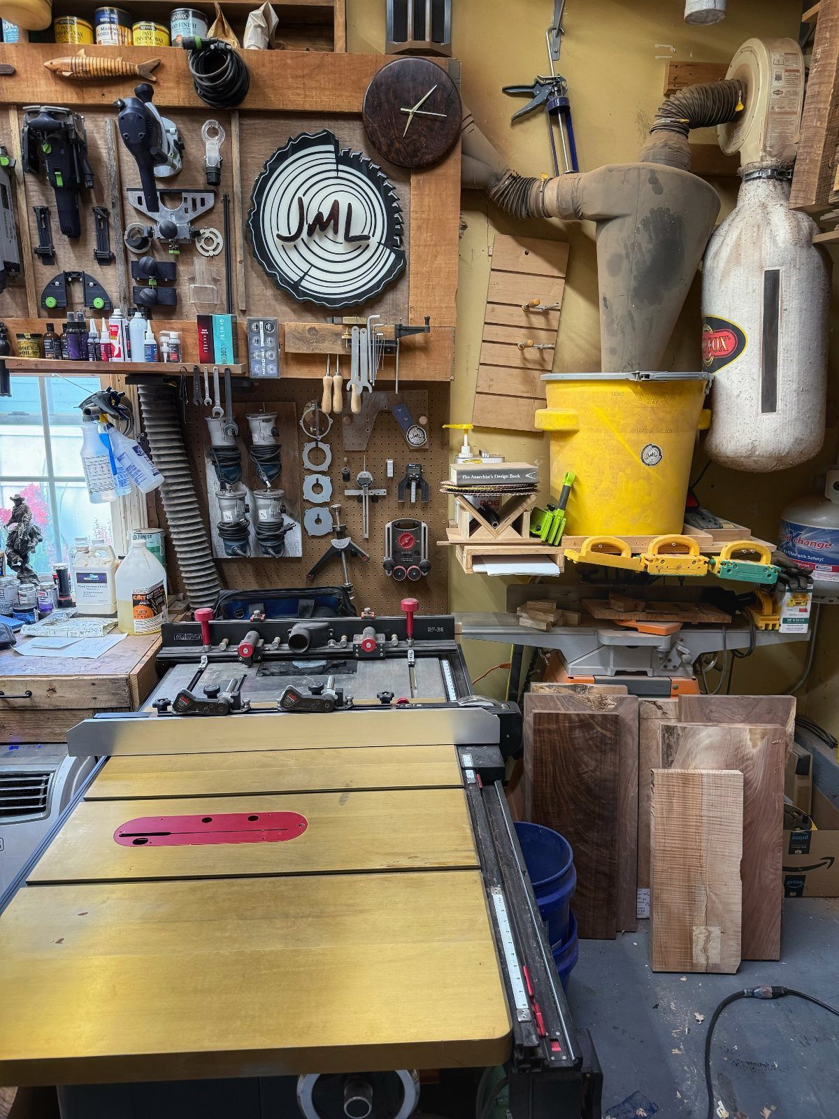 Table saw and tool-lined walls in a cluttered garage woodworking shop.