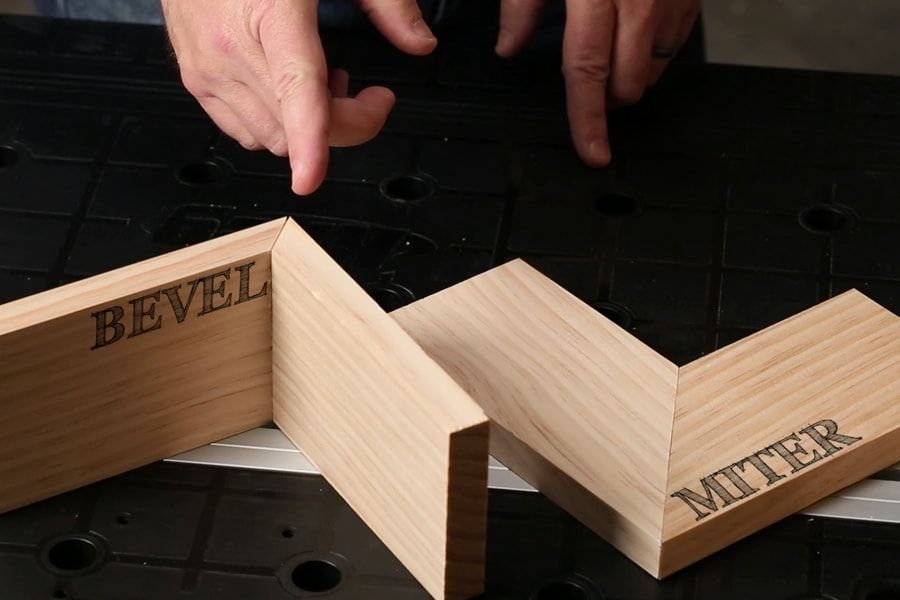 Wood samples showing bevel and miter joints on a black workbench